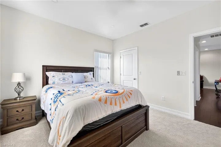 Bedroom featuring light carpet and recessed lighting