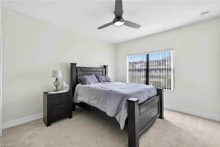 Bedroom featuring light colored carpet and ceiling fan