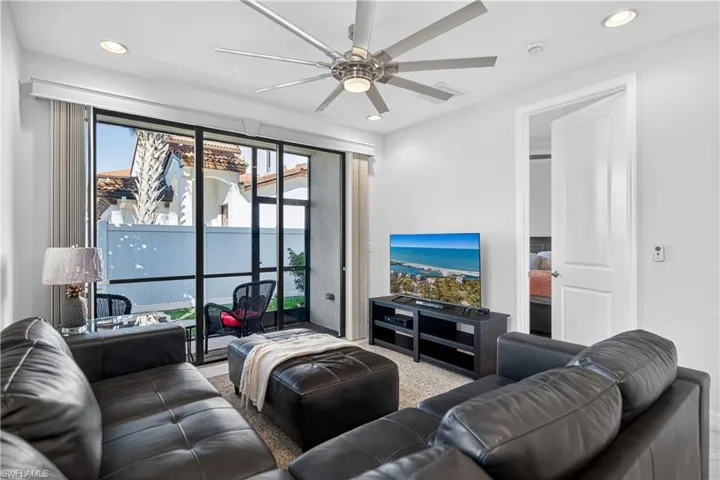 Living area featuring recessed lighting and a ceiling fan