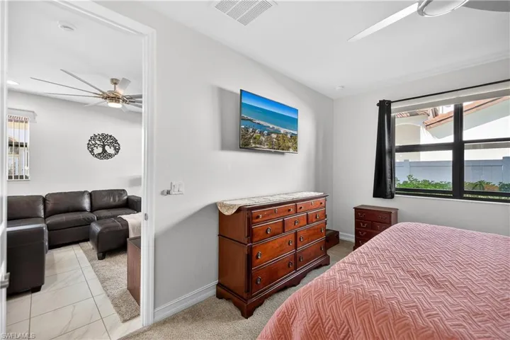 Bedroom featuring ceiling fan and light colored carpet