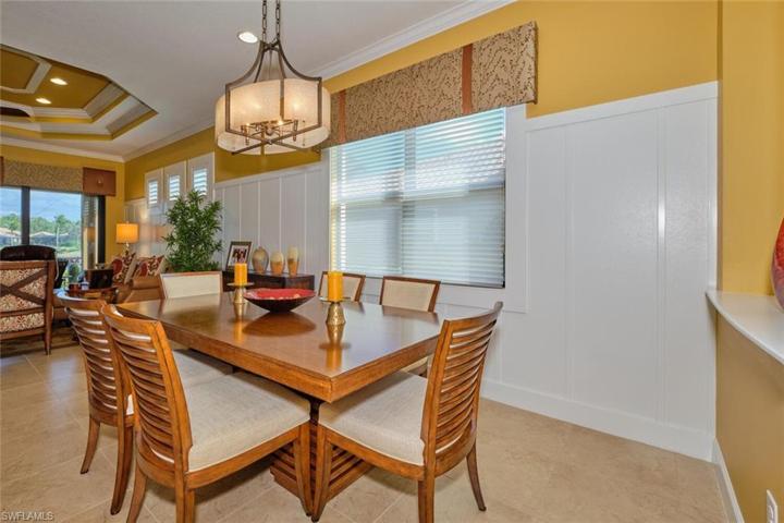 Spacious Dining area with custom window treatments and lighting fixtures.