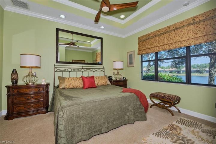 Main bedroom with custom accents everywhere! Windows, painting, crown molding, mirror made special for the room.