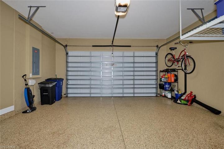 Two car garage with epoxy floors, and an overhead storage unit.