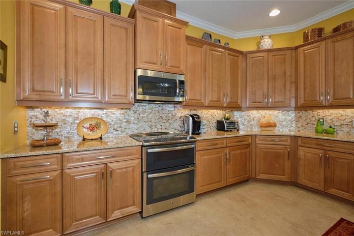 Quartz countertops, glass tile backsplash, and soft close drawers.