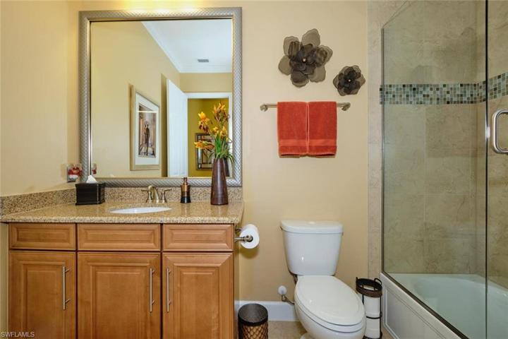 Hall bath with more designer mirrors and upgraded glass enclosure.
