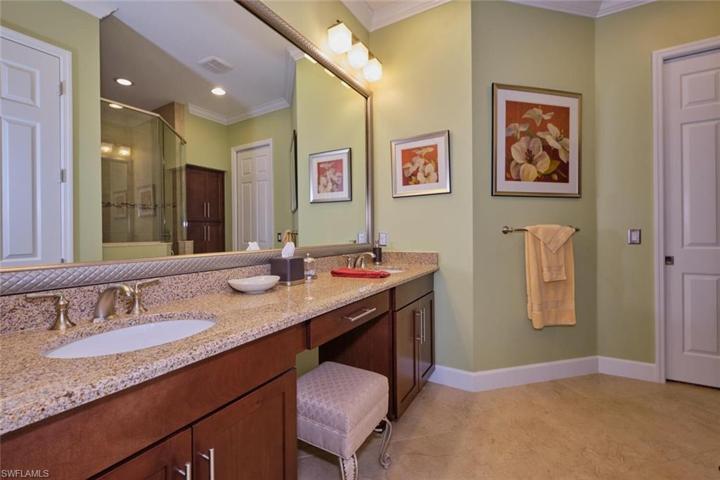 Double sinks and custom mirror in the main bath.