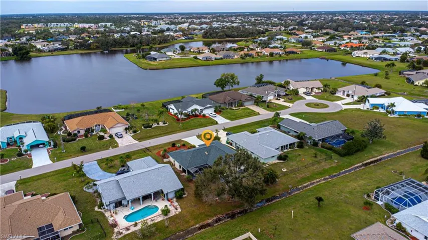 Birds eye view of property with a water view