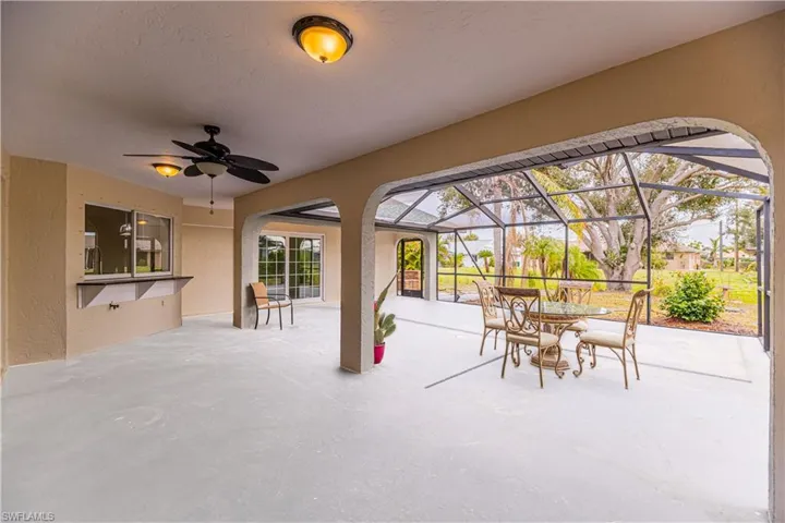 View of patio featuring a lanai and ceiling fan
