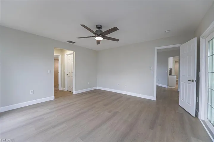 Spare room featuring light wood-type flooring and ceiling fan