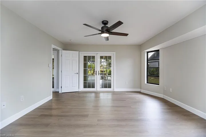 Empty room with wood-type flooring and ceiling fan