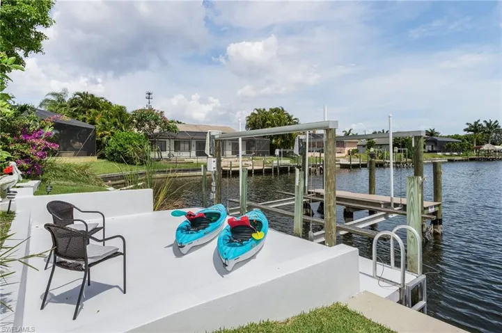 View of dock featuring boat lift and a water view