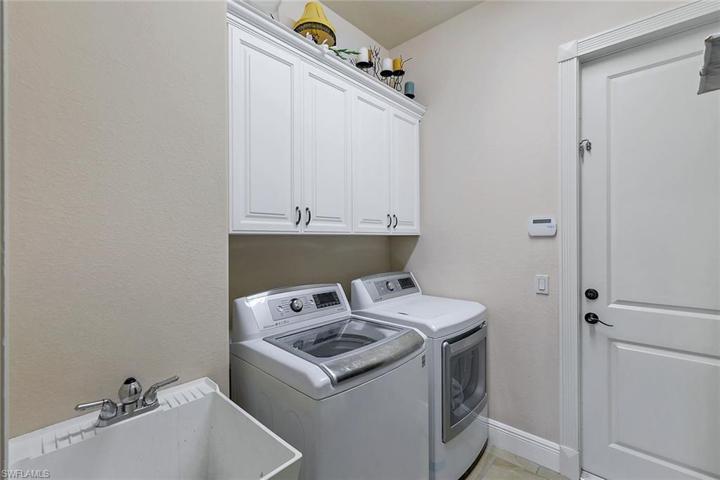 Inside Laundry with Sink- Door into the 3 Car Garage