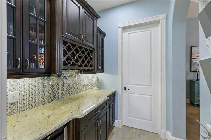 Butler Pantry Bar, Mini Fridge, Door to Laundry Room, Entrance to Dining Room on the Right