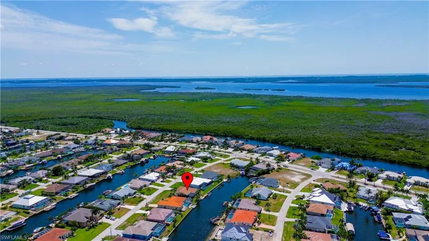 Birds eye view of property with a water view