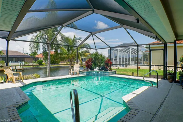 View of swimming pool featuring a patio area and glass enclosure