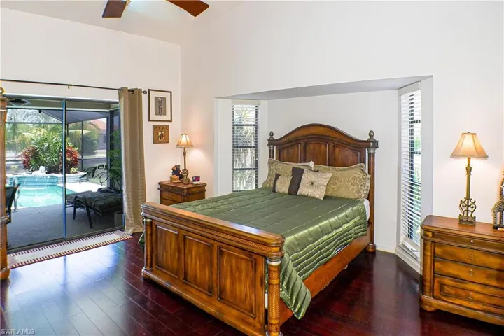 Bedroom featuring access to outside, ceiling fan, and dark hardwood / wood-style flooring