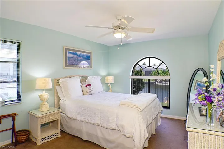 Carpeted bedroom with ceiling fan