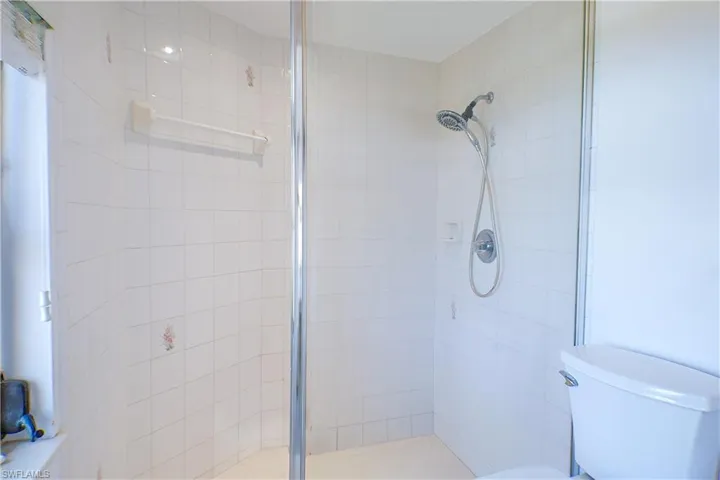 Bathroom featuring walk in shower and toilet