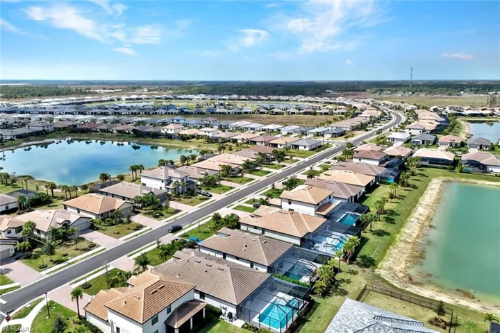 Aerial view of residential area featuring a large body of water