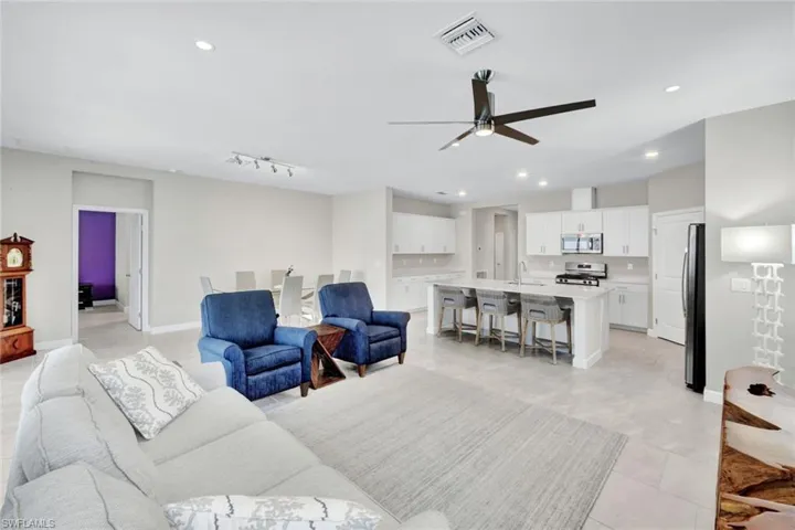 Living area with a ceiling fan and recessed lighting