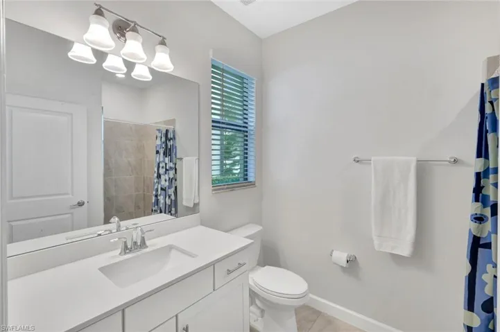 Bathroom featuring vanity and a shower with shower curtain