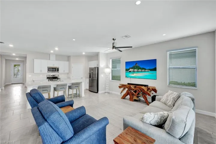 Living room featuring recessed lighting and ceiling fan