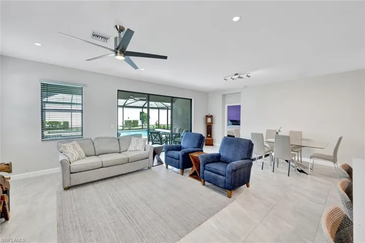 Living area featuring a sunroom, ceiling fan, and recessed lighting