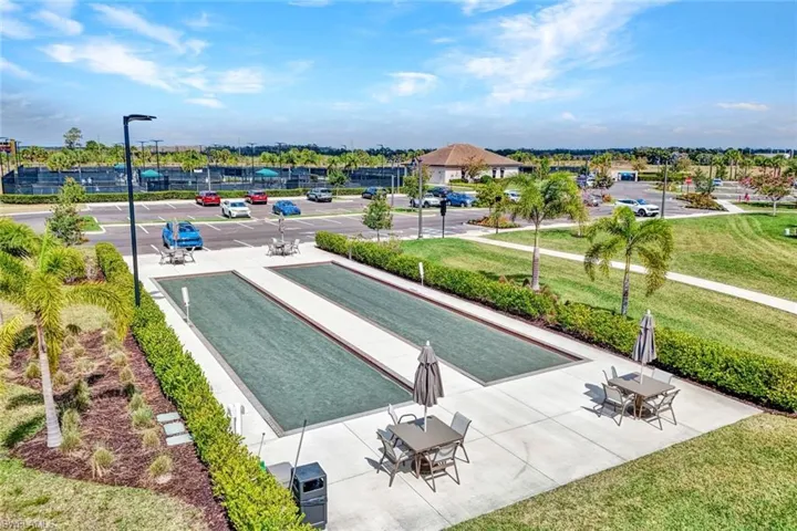 View of property's community featuring a bocce ball area and a patio area