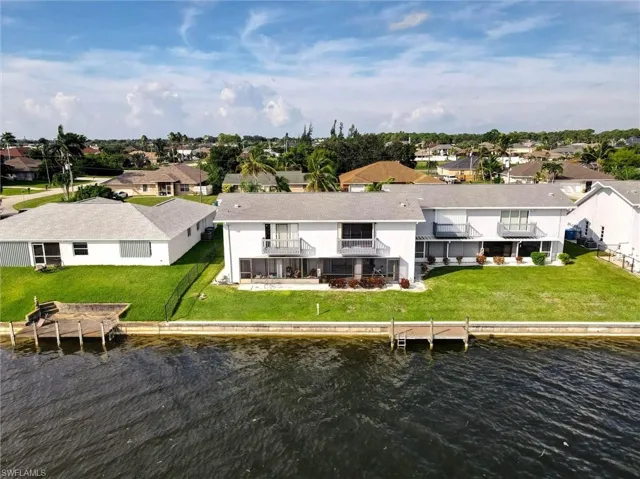 Waterfront property with extensive green space, private docks, and multiple balconies