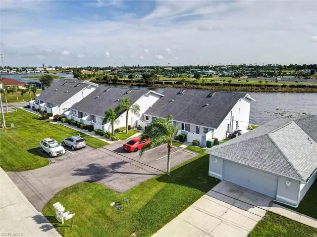 Waterfront townhome community with pitched shingle roofs and individual garages