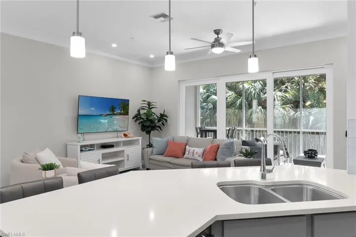 KITCHEN OPENS TO LIVING ROOM AND BALCONY VIEW