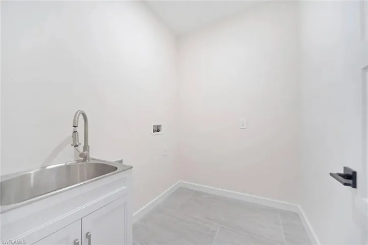 Washroom featuring washer hookup and baseboards