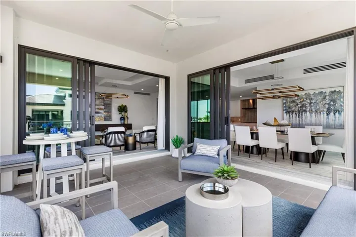 Living room with ceiling fan and tile patterned floors