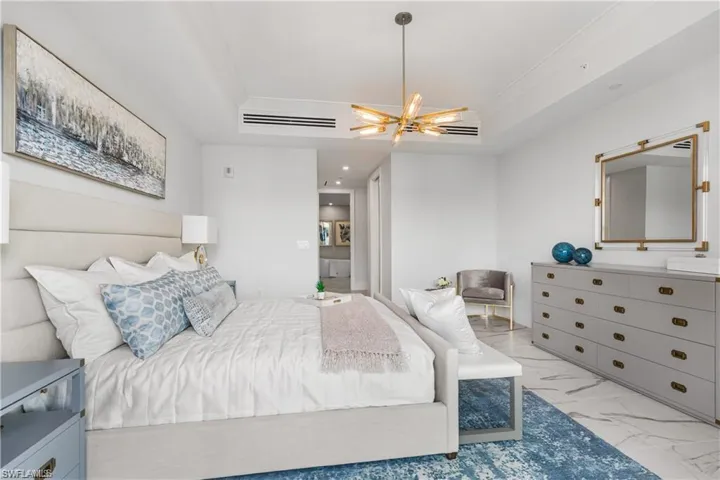 Bedroom featuring ceiling fan and a tray ceiling