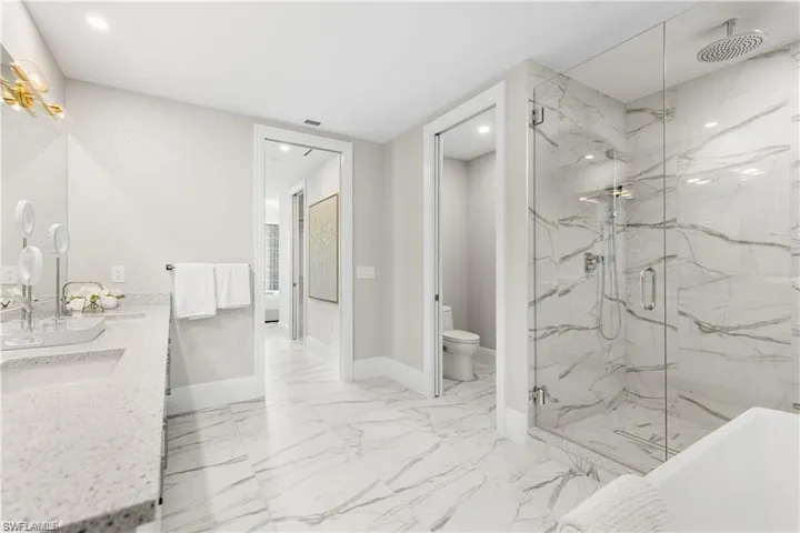 Full bathroom with vanity, toilet, and independent shower and bath