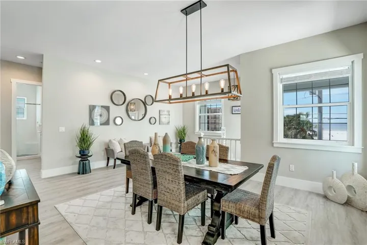 Dining area featuring light wood-style flooring and recessed lighting - Virtually Edited Image