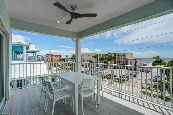 Wooden terrace with a ceiling fan and GULF SUNSETS - Virtually Edited Image