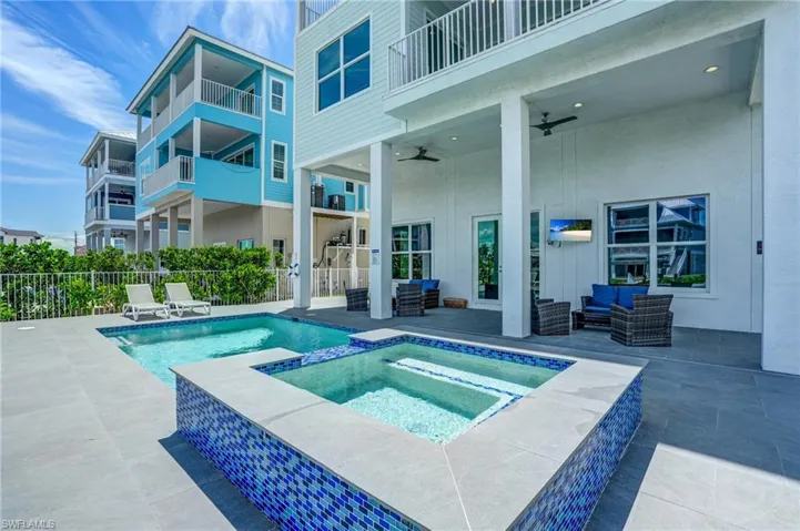 Inviting you to come in the SPA, and featuring  a patio, an outdoor hangout area, a pool with connected hot tub, and a ceiling fan - Virtually Edited Image