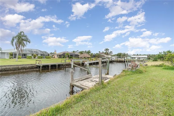Dock area with a yard and a water view