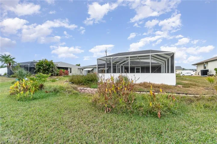 View of yard with glass enclosure