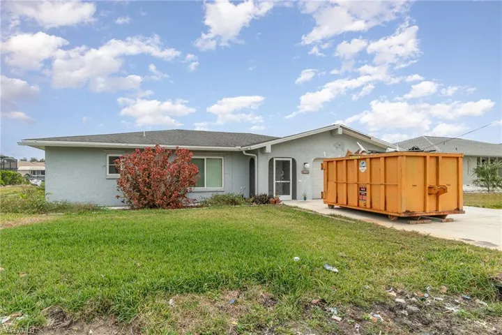 Rear view of house featuring a yard