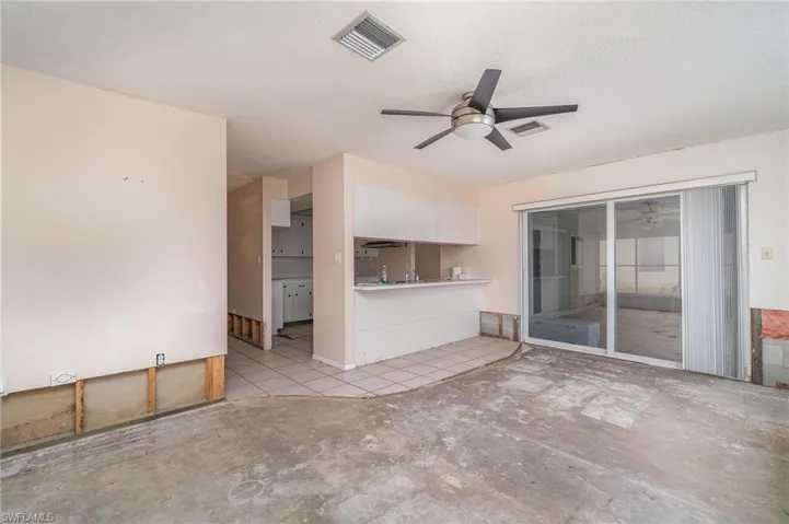 Unfurnished living room with a textured ceiling and ceiling fan