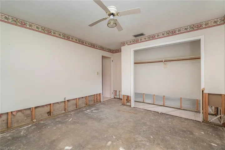 Unfurnished bedroom with a closet and ceiling fan