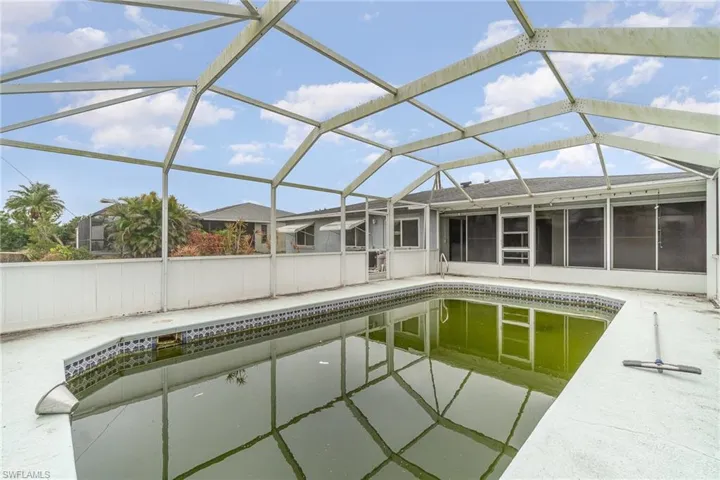View of swimming pool with a lanai and a patio area