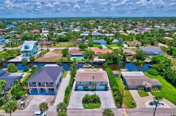 Aerial perspective of suburban area featuring a nearby body of water