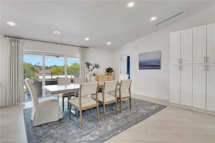 Dining space featuring vaulted ceiling, recessed lighting, and light wood finished floors