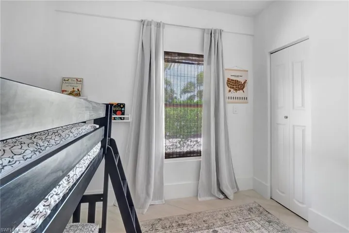 Bedroom with a closet and baseboards