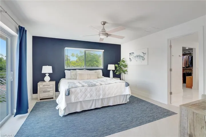 Bedroom featuring access to outside, a ceiling fan, and light tile patterned floors