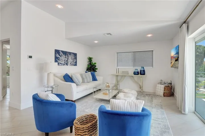 Living area with vaulted ceiling and recessed lighting