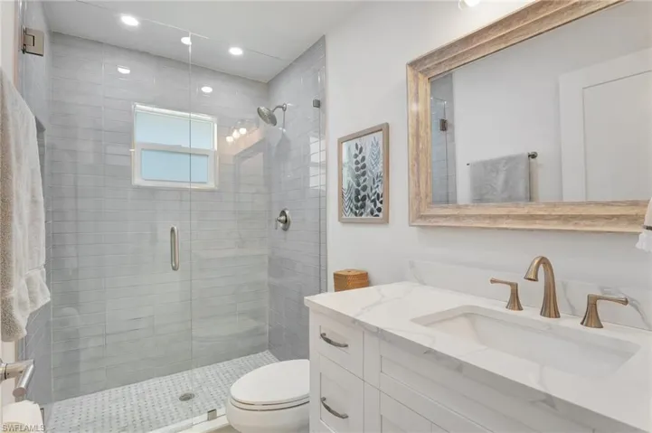 Bathroom featuring vanity, a stall shower, and recessed lighting